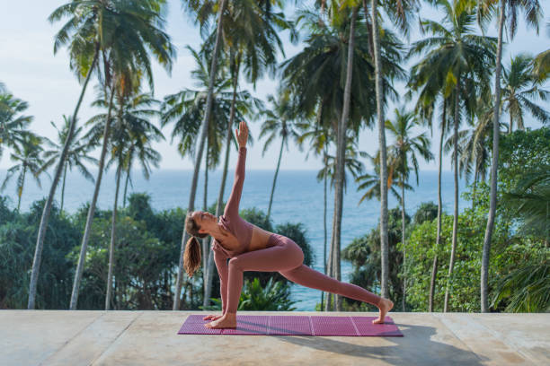 istock Young woman performs yoga outdoors 2093771524
