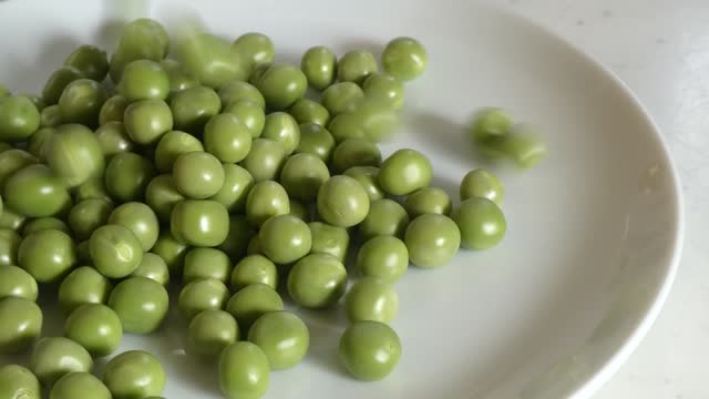 Pour green peas into the dish intermittently