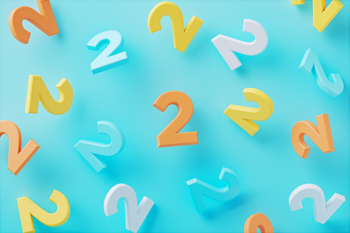 Colorful number twos on blue background. Horizontal composition.