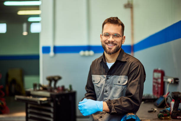 istock A smiling mechanic technician working at his car repair service, posing for the camera. 2093794427