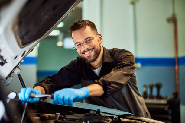 istock A portrait of a smiling mechanic, posing for the camera, holding and using some tools. 2093794935