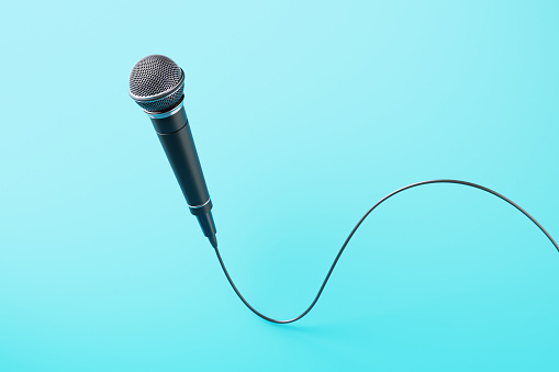 Microphone on blue background. Horizontal composition.