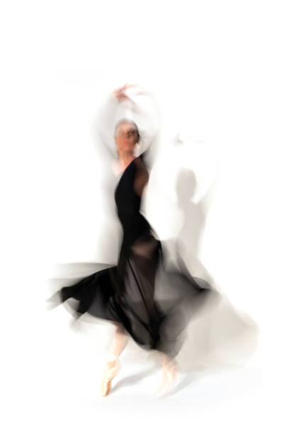 istock Young ballerina in black skirt dances in studio light.Long exposure. White Background 2093808607