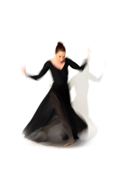 istock Young ballerina in black skirt dances in studio light.Long exposure. White Background 2093809148