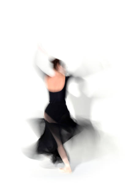 istock Young ballerina in black skirt dances in studio light.Long exposure. White Background 2093809719