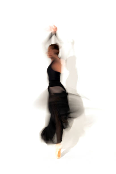 istock Young ballerina in black skirt dances in studio light.Long exposure. White Background 2093810251