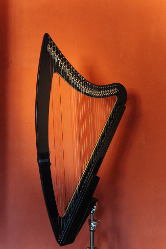 Electronic modern harp on an orange background