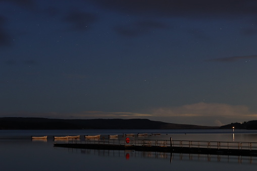 Starry night skies over a countryside lake - Kielder Water, Northumberland