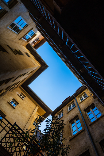 View towards the sky from a traboule, typical courtyard of medieval buildings in Old Lyon