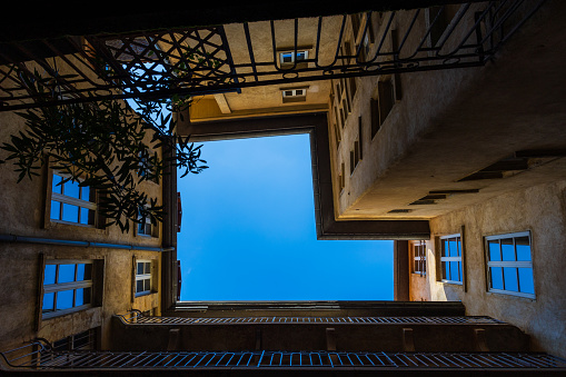 View towards the sky from a traboule, typical courtyard of medieval buildings in Old Lyon