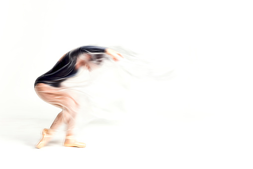 Graceful ballerina dancing with transparent nylon