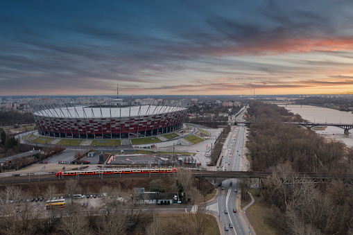 Warszawa, Poland - January 27, 2024: The National Stadium in Warsaw illuminated in Poland's national colors at sunset.