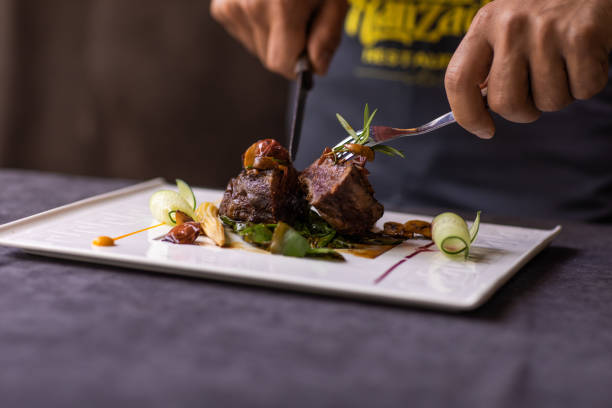 istock A man is cutting a piece of meat on a plate 2093897569