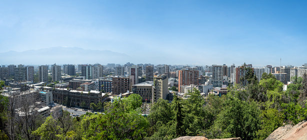 wide elevated panoramic view on modern Santiago skyline with mountain range in the background