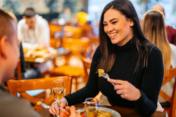 istock Young Couple Eating Belgian Waffles And Drinking Champagne In A Pub 2093935638
