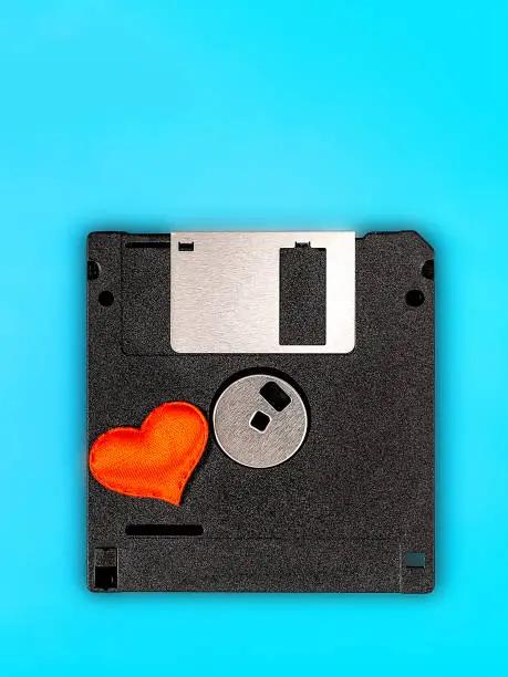 Floppy Disk Drive with a Red Heart on the Blue Background closeup