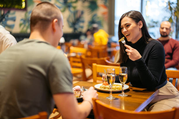 young couple eating belgian waffles and drinking champagne in a pub - waffle eating meal food and drink zdjęcia i obrazy z banku zdjęć