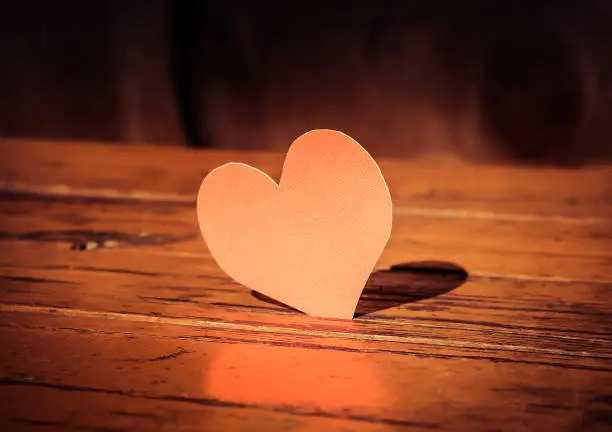 Toned Photo of Red Heart Shape on the Old Wooden Board closeup