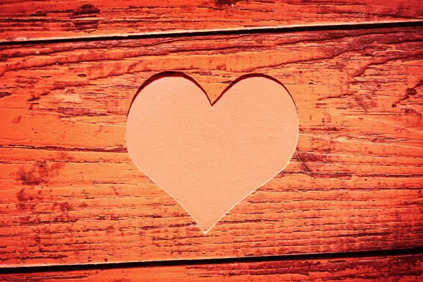 Toned Photo of Red Heart Shape on the Old Wooden Board closeup
