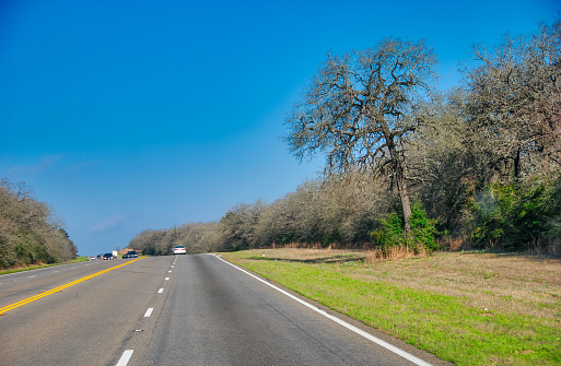 Traffic along Texas countryside road in spring season