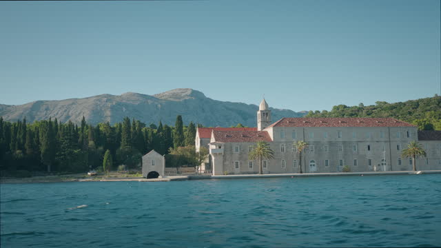 Architecture of Franciscan monastery on the Mediterranean island. Summer time on Badija island, Korcula. View from the sea.