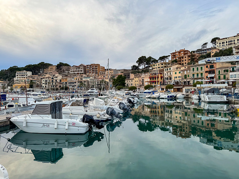 As the sun sets over the picturesque Port de Soller Marina Bay, the tranquil beauty of this coastal gem in Mallorca, Spain, comes to life. The bay, with its sparkling waters and charming marina, offers a captivating scene that is perfect for capturing the essence of a Mediterranean dusk.