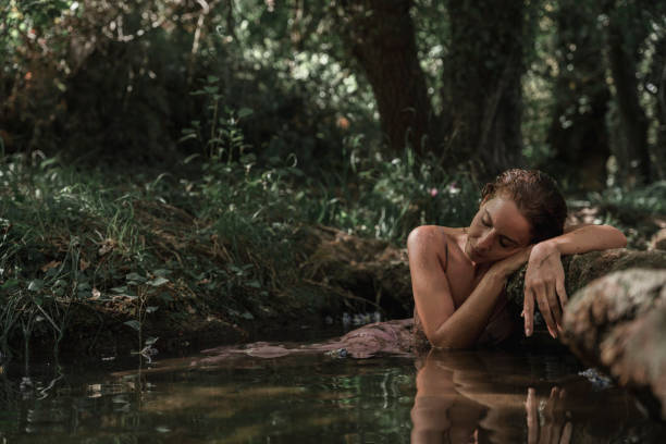 istock Relaxed woman leans against a rock 2093959844