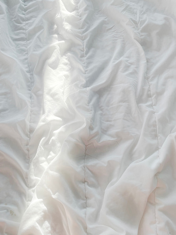 ray of sunlight on the morning bed, on the blanket. aesthetic photo