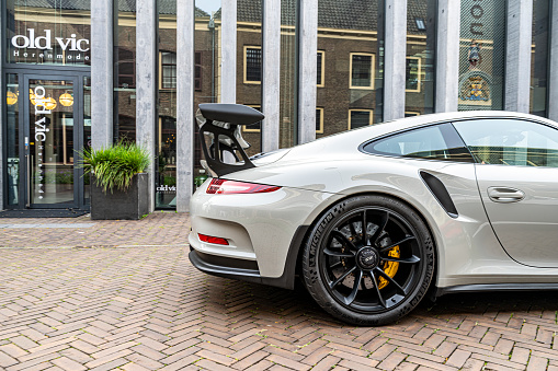 Porsche 911 GT3 RS sports car generation 991 driving on the street in Zwolle. The GT3 RS is a lightweight performance version of the Porsche 911 with improved aerodynamics.