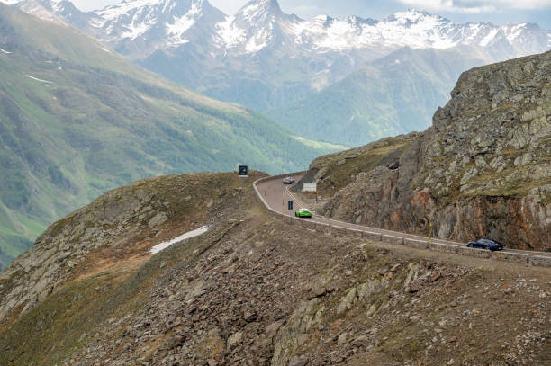 porsche 911 sports cars driving on an alpine road in the mountains - ferrari italian culture porsche porsche 911 ストックフォトと画像