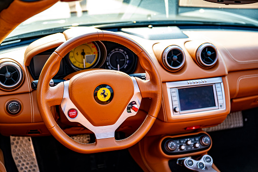 Ferrari California convertible sports car dashboard. The car is parked on a street in Zwolle.  The Ferrari California is a grand touring sports car produced by the Italian automaker Ferrari. The California  (Type F149) is powered by a front-mid mounted, direct-injection 4.3-liter V8 engine.