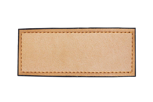 istock Brown leather belt strap closeup isolated on white. Brown stitched leather seam frame label tag isolated on white. 2094005018