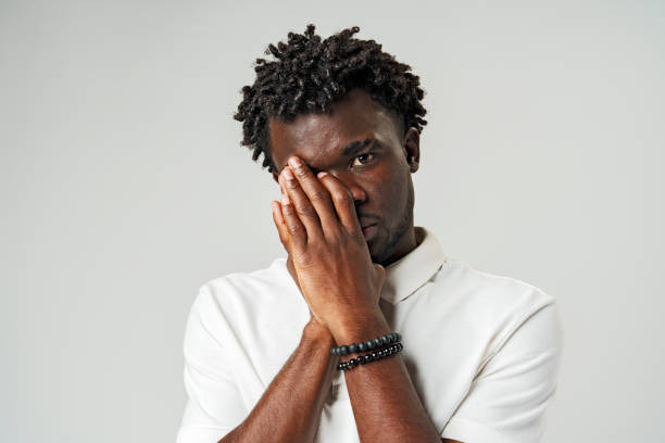 istock Young African Man Clutching His Face in Distress 2094005638