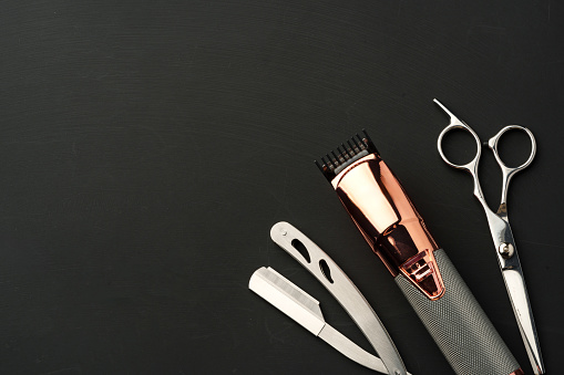 Tools for barbershop on black background studio shot top view
