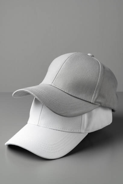 istock Two White Baseball Caps on a White Background 2094005653
