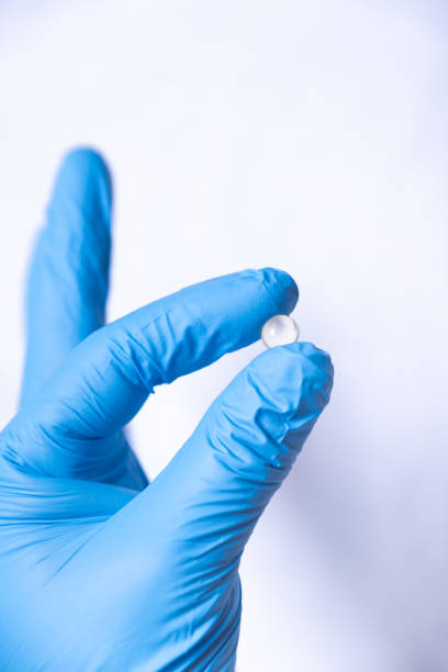 istock Hand with a blue latex glove, clutching a tablet. 2094014760