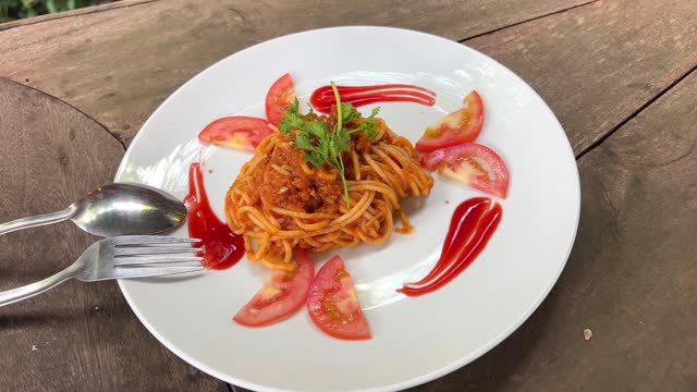 Tom Yam Kung Spaghetti in white plate. Fusion Food thai and italian.