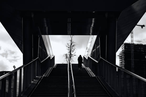 istock Woman is going up the stairs - Monochrome 2094022172