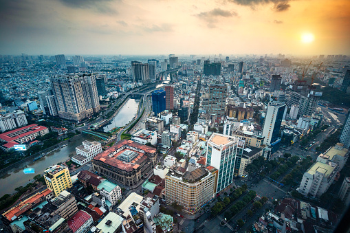 Aerial view of Ho Chi Minh City, formerly Saigon, at sunset showcasing the bustling urban landscape and dense architectural spread.