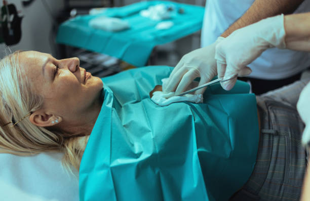 istock a surgeon with his nurse in the operating room performs an operation on a woman 2094029456