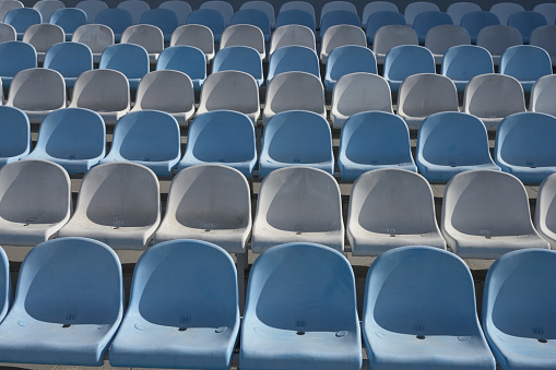 Empty benches in sports stadium.  Represents lockdown in sports due to coronavirus.