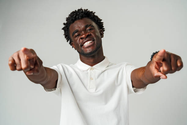 istock Young African Man Pointing at Something Against Gray Background 2094097138