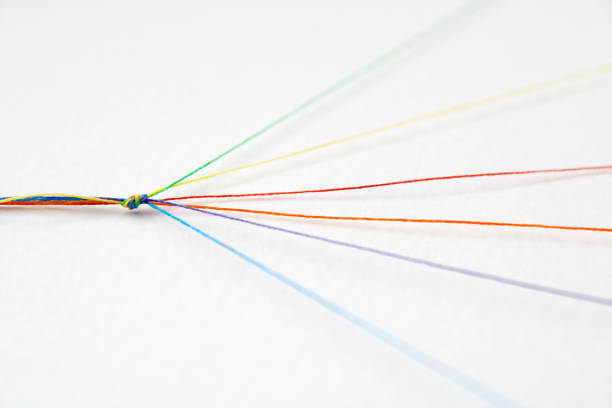 Threads of different colors that join together in a knot and take different directions