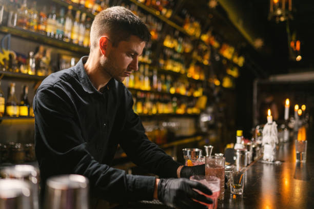 istock Bartender gives prepared glasses with drinks to visitors 2094121566