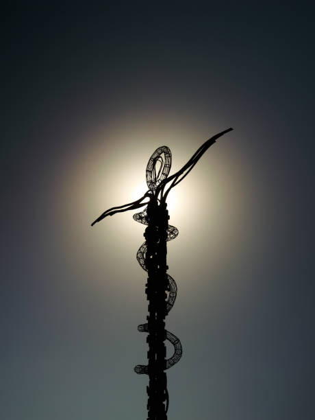 Two climbing ropes thrown over rock cliff twisting and unfurling in the air