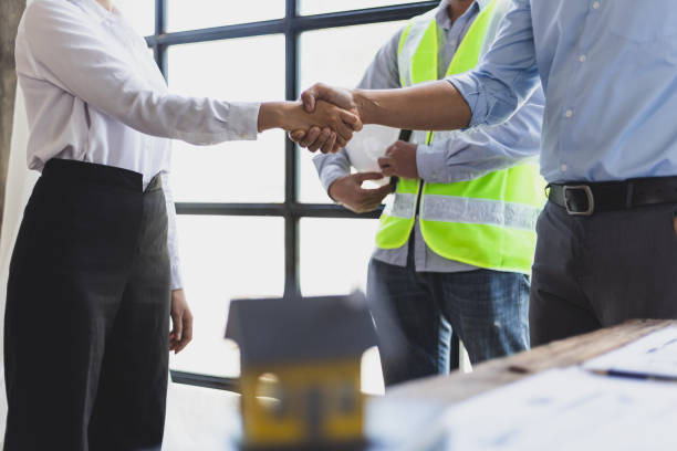 istock Collaboration of engineers, architects and contractors. Architects hand in hand promote teamwork cooperation of colleagues in construction projects. 2094183183