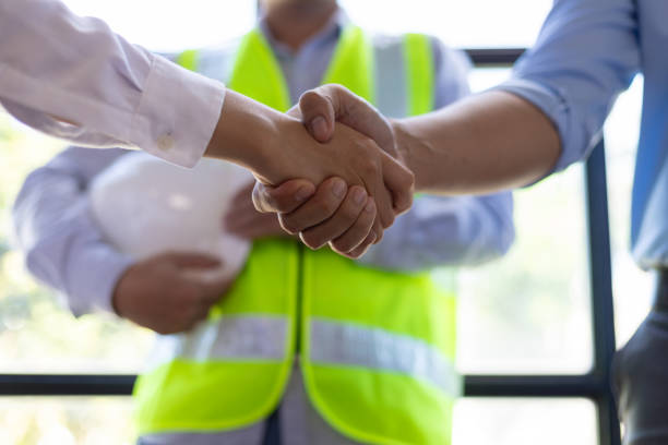 istock Collaboration of engineers, architects and contractors. Architects hand in hand promote teamwork cooperation of colleagues in construction projects. 2094186850