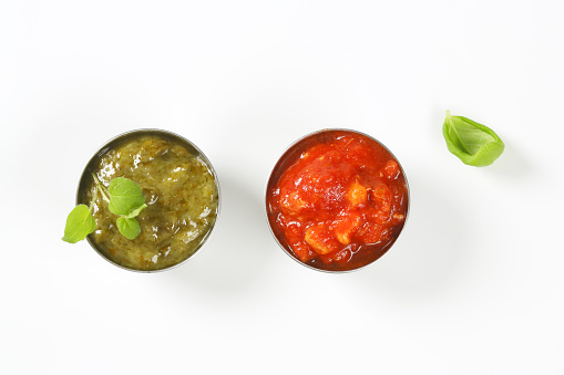 Basil pesto and tomato salsa  in metal bowls