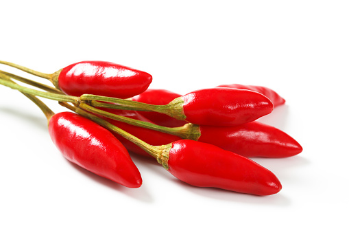 Small red chili peppers on white background