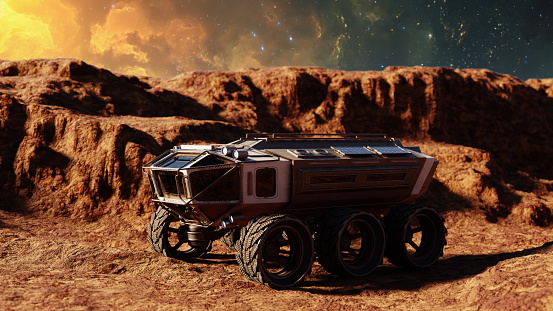 Robotic rover traverses a rocky, Mars-like surface under a dramatic evening sky. 3d render
